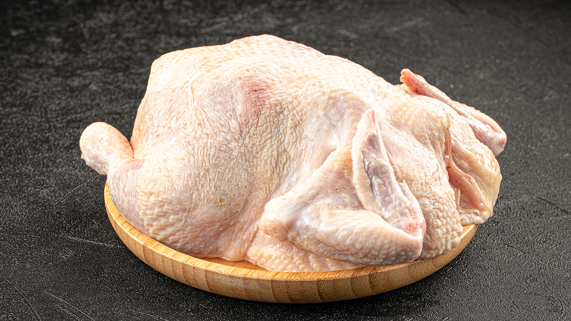 Fresh raw whole chicken on a plate