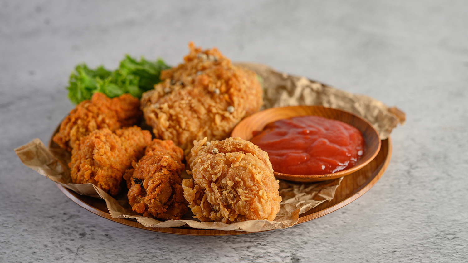 Crispy fried chicken on a plate with tomato sauce, Selective focus.