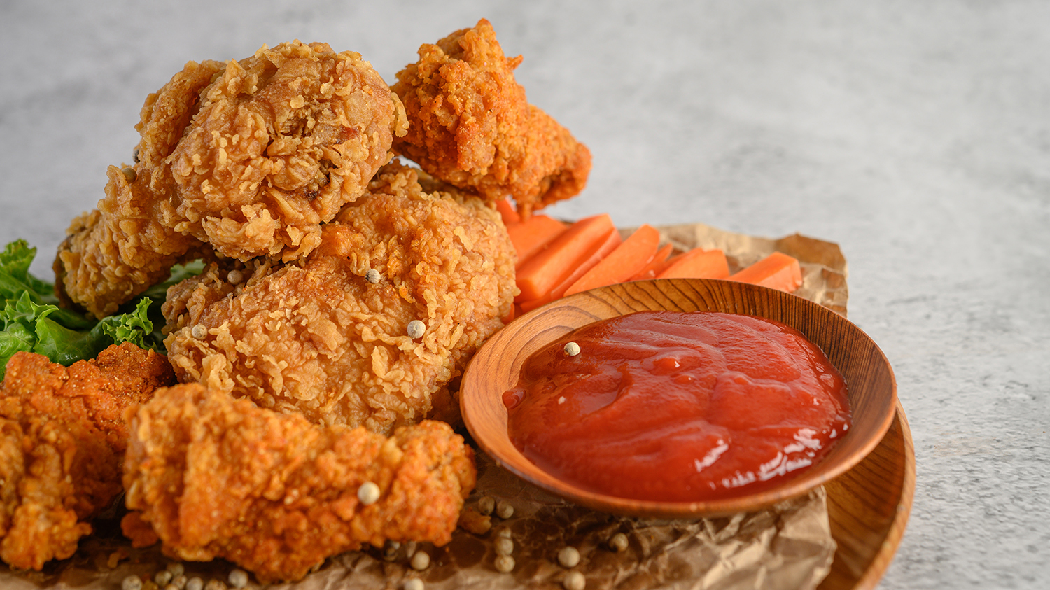 Crispy fried chicken on a plate with tomato sauce, Selective focus.
